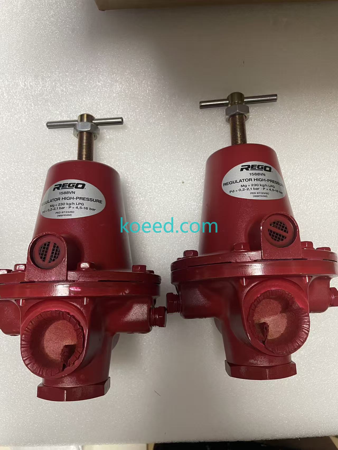 Two red REGO 1588VN units labelled REGULATOR HIGH-PRESSURE, Mg = 230 kg/h LPG, Pd = 0.2–2.1 bar and P = 4.5–16 bar; these are printed values.